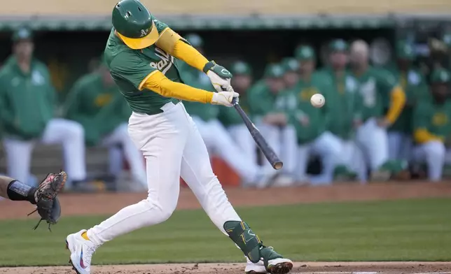 Oakland Athletics' Tyler Nevin hits an RBI single against the Pittsburgh Pirates during the second inning of a baseball game in Oakland, Calif., Tuesday, April 30, 2024. (AP Photo/Jeff Chiu)
