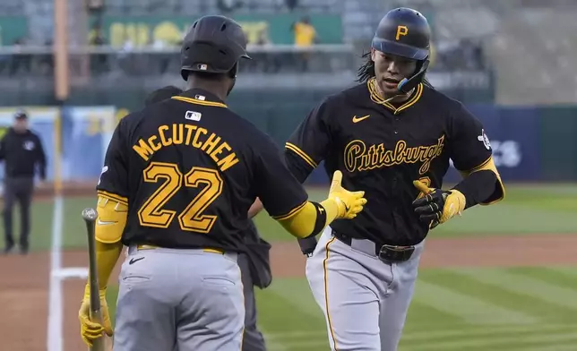 Pittsburgh Pirates' Connor Joe, right, is congratulated by Andrew McCutchen (22) after hitting a home run during the first inning of a baseball game against the Oakland Athletics in Oakland, Calif., Tuesday, April 30, 2024. (AP Photo/Jeff Chiu)