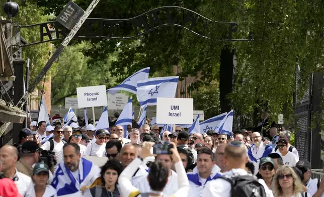 People carry Israel's flags as they march through the former Nazi German death camp of Auschwitz-Birkenau during the annual Holocaust remembrance event, the "March of the Living" in memory of the six million Holocaust victims in Oswiecim, Poland, Monday, May 6, 2024. The event comes amid the dramatic backdrop of the violence of the Israel-Hamas war after the Oct. 7 Hamas attack, the deadliest violence against Jews since the Holocaust, and as pro-Palestinian protests sweep U.S. campuses. (AP Photo/Czarek Sokolowski)