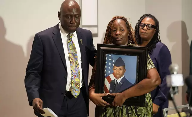 Attorney Ben Crump walks with Chantimekki Fortson, mother of Roger Fortson, a U.S. Navy airman, as they arrive for a news conference about his death, Thursday, May 9, 2024, in Ft. Walton Beach, Fla. Fortson was shot and killed by police in his apartment on May 3, 2024. (AP Photo/Gerald Herbert)