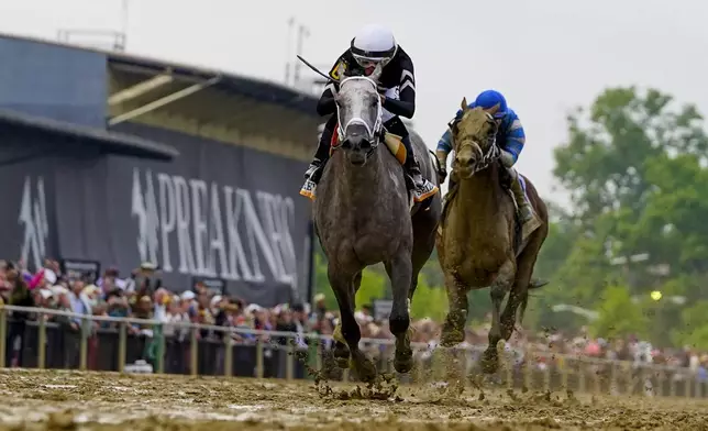 Jaime Torres, left, atop Seize The Grey, edges out Flavien Prat, atop Catching Freedom, to win the Preakness Stakes horse race at Pimlico Race Course, Saturday, May 18, 2024, in Baltimore. (AP Photo/Julio Cortez)