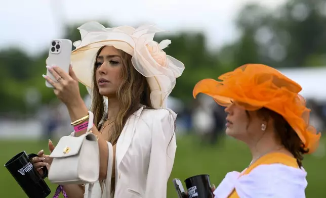 Women wear decorative hats ahead of the Preakness Stakes horse race at Pimlico Race Course, Saturday, May 18, 2024, in Baltimore. (AP Photo/Nick Wass)