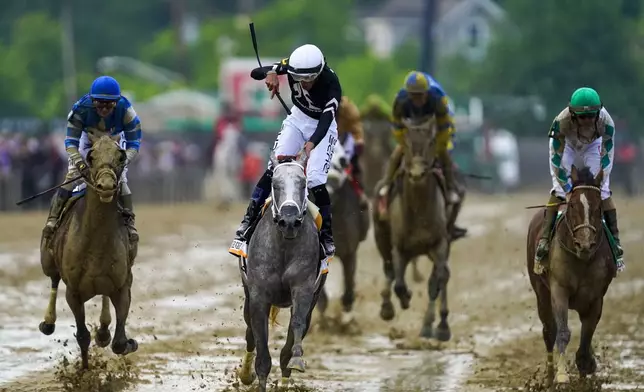 Jaime Torres, center, atop Seize The Grey, leads reacts after winning the Preakness Stakes horse race at Pimlico Race Course, Saturday, May 18, 2024, in Baltimore. (AP Photo/Nick Wass)