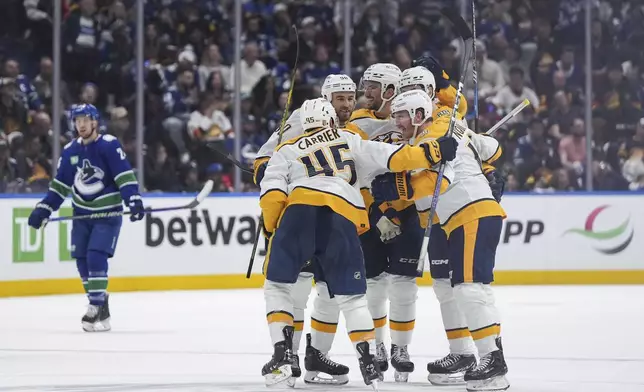 Nashville Predators' Alexandre Carrier, from left to right, Ryan O'Reilly, Roman Josi, Gustav Nyquist and Filip Forsberg celebrate Carrier's goal against the Vancouver Canucks during the third period in Game 5 of an NHL hockey Stanley Cup first-round playoff series, in Vancouver, British Columbia, on Tuesday, April 30, 2024. (Darryl Dyck/The Canadian Press via AP)