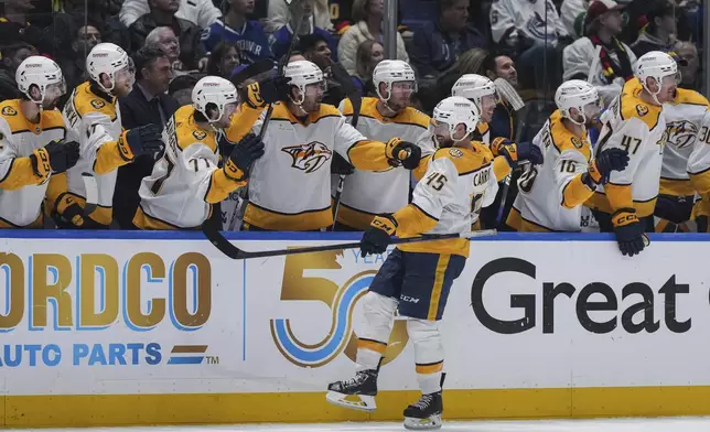 Nashville Predators' Alexandre Carrier (45) celebrates his goal against the Vancouver Canucks during the third period in Game 5 of an NHL hockey Stanley Cup first-round playoff series, in Vancouver, British Columbia, on Tuesday, April 30, 2024. (Darryl Dyck/The Canadian Press via AP)