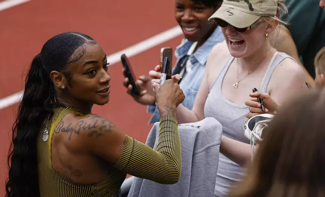 Sha'Carri Richardson talks with reporters after winning the women's 100 meters at the Prefontaine Classic track and field meet Saturday, May 25, 2024, in Eugene, Ore. (AP Photo/Thomas Boyd)