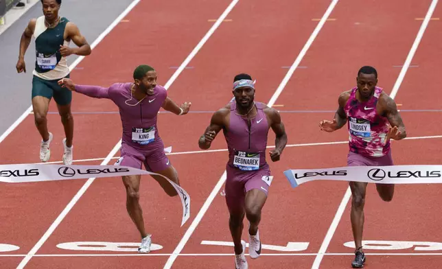 Kenneth Bednarek wins the men's 200 meters at the Prefontaine Classic track and field meet Saturday, May 25, 2024, in Eugene, Ore. Courtney Lindsey, right, was second, and Kyree King, second from left, was third. (AP Photo/Thomas Boyd)