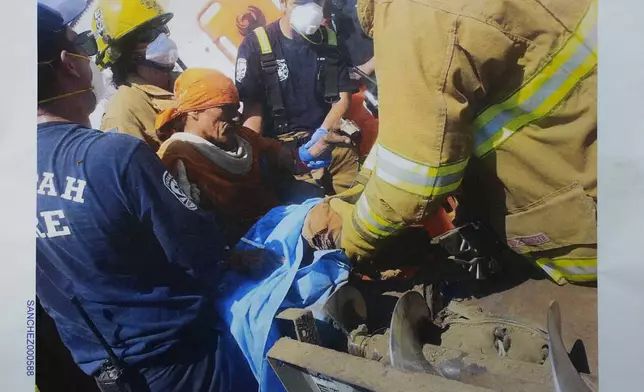 This 2015 photo shows first responders as they work to free Blas Sanchez from an auger that snagged and mutilated his right leg, at Hickman's Family Farms, in Tonopah, Ariz. Nationwide, prisoners are increasingly being placed in dangerous jobs, sometimes with little or no training. They are part of a labor system that, often by design, largely denies them basic rights and protections guaranteed to other American workers. (Provided by Blas Sanchez via AP)