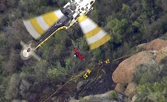 FILE - In this Feb. 25, 2016 still frame from video provided by KABC-TV, a Los Angeles County Fire Department helicopter lifts an inmate firefighter after she was injured fighting a brush fire in the Santa Monica Mountains above Malibu, Calif. California corrections officials say the firefighter, identified as Shawna Lynn Jones, died Friday, Feb. 26, a day after she was struck by a large rock while working the fire. (KABC-TV via AP) MANDATORY CREDIT TV OUT