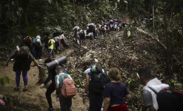 Migrants walk across the Darien Gap from Colombia to Panama in hopes of reaching the U.S., Tuesday, May 9, 2023. The image was part of a series by Associated Press photographers Ivan Valencia, Eduardo Verdugo, Felix Marquez, Marco Ugarte Fernando Llano, Eric Gay, Gregory Bull and Christian Chavez that won the 2024 Pulitzer Prize for feature photography. (AP Photo/Ivan Valencia)
