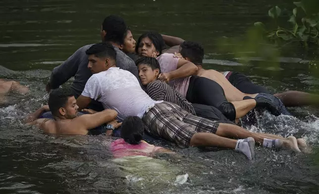 Migrants cross the Rio Bravo on an inflatable mattress into the United States from Matamoros, Mexico, on May 9, 2023. The image was part of a series by Associated Press photographers Ivan Valencia, Eduardo Verdugo, Felix Marquez, Marco Ugarte Fernando Llano, Eric Gay, Gregory Bull and Christian Chavez that won the 2024 Pulitzer Prize for feature photography. (AP Photo/Fernando Llano)