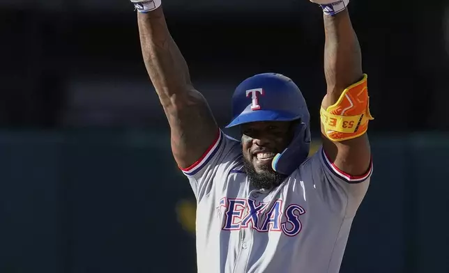 Texas Rangers' Adolis García reacts after hitting an RBI double against the Oakland Athletics during the eighth inning in the second baseball game of a doubleheader Wednesday, May 8, 2024, in Oakland, Calif. (AP Photo/Godofredo A. Vásquez)