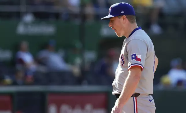 Texas Rangers pitcher Josh Sborz walks off the field with an injury during the sixth inning in the second baseball game of the team's doubleheader against the Oakland Athletics, Wednesday, May 8, 2024, in Oakland, Calif. (AP Photo/Godofredo A. Vásquez)