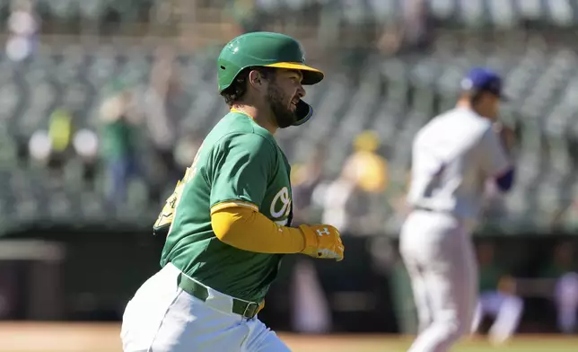 Oakland Athletics' Shea Langeliers runs the bases after hitting a two-run home run off Texas Rangers pitcher Jack Leiter, background, during the second inning in the second baseball game of a doubleheader Wednesday, May 8, 2024, in Oakland, Calif. (AP Photo/Godofredo A. Vásquez)