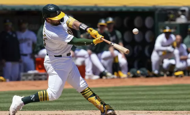 Oakland Athletics' Shea Langeliers hits a two-run home run during the second inning in the first baseball game of a doubleheader against the Texas Rangers, Wednesday, May 8, 2024, in Oakland, Calif. (AP Photo/Godofredo A. Vásquez)