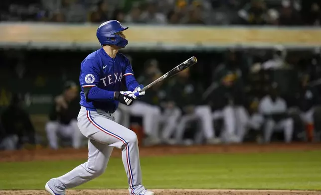 Texas Rangers' Corey Seager watches his three-run home run against the Oakland Athletics during the eighth inning of a baseball game Monday, May 6, 2024, in Oakland, Calif. (AP Photo/Godofredo A. Vásquez)