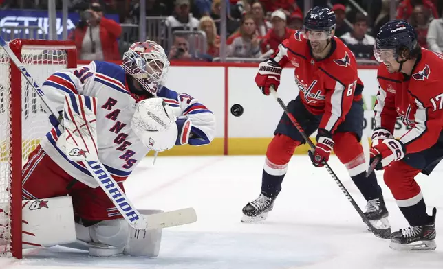 New York Rangers goaltender Igor Shesterkin (31) makes a save during the first period against the Wahington Capitals in Game 3 of an NHL hockey Stanley Cup first-round playoff series, Friday, April 26, 2024, in Washington. (AP Photo/Tom Brenner)