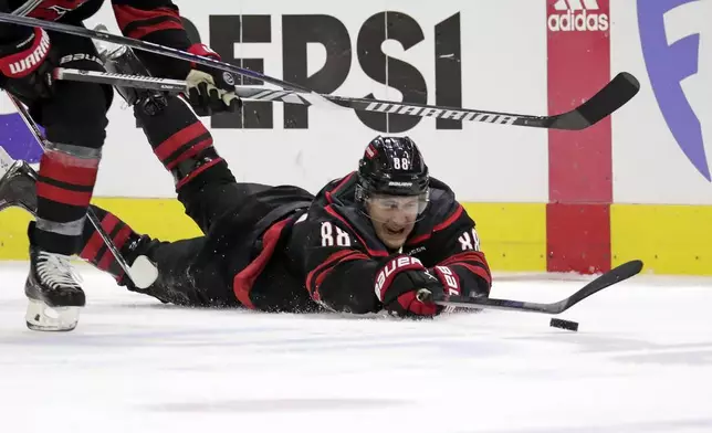 Carolina Hurricanes center Martin Necas dives for the puck against the New York Rangers during the second period in Game 3 of an NHL hockey Stanley Cup second-round playoff series Thursday, May 9, 2024, in Raleigh, N.C. (AP Photo/Chris Seward)