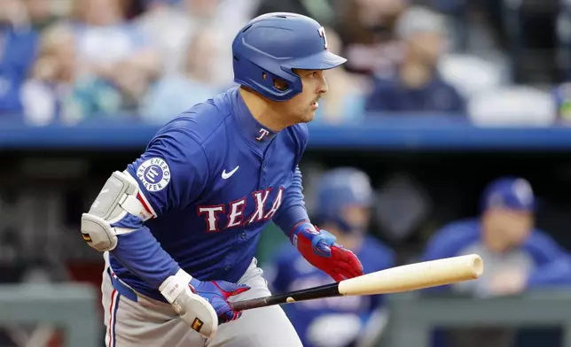 Texas Rangers' Nathaniel Lowe watches his two-run single during the fourth inning of a baseball game against the Kansas City Royals in Kansas City, Mo., Saturday, May 4, 2024. (AP Photo/Colin E. Braley)