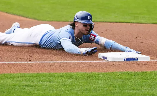 Kansas City Royals' Bobby Witt Jr. slides into third base after a hitting a triple during the first inning of a baseball game against the Texas Rangers, Sunday, May 5, 2024, in Kansas City, Mo. (AP Photo/Nick Tre. Smith)