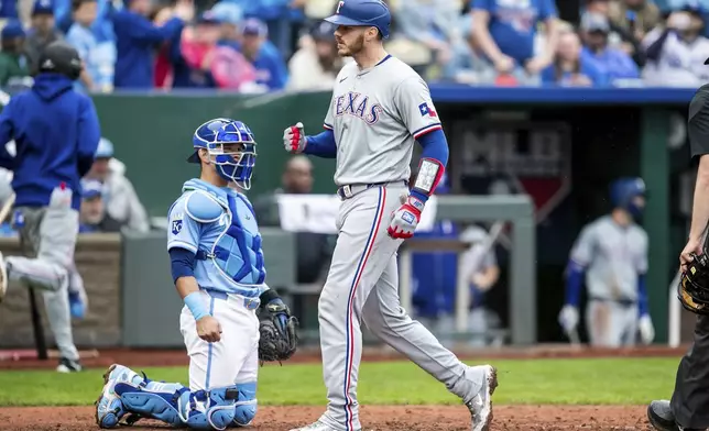 Texas Rangers catcher Jonah Heim reacts after hitting a homer during a baseball game against the Kansas City Royals, Sunday, May 5, 2024, in Kansas City, Mo. (AP Photo/Nick Tre. Smith)
