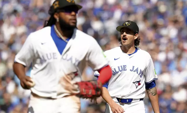 Toronto Blue Jays pitcher Kevin Gausman, right, celebrates as he walks off the mound at the end of the top of fifth inning of a baseball game against the Tampa Bay Rays, Saturday, May 18, 2024, in Toronto. (Chris Young/The Canadian Press via AP)