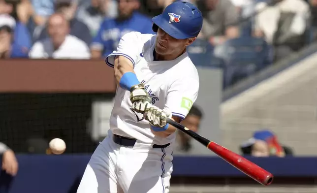 Toronto Blue Jays' Daulton Varsho (25) hits a two-run double during the fifth inning of a baseball game against the Tampa Bay Rays, Saturday, May 18, 2024, in Toronto. (Chris Young/The Canadian Press via AP)