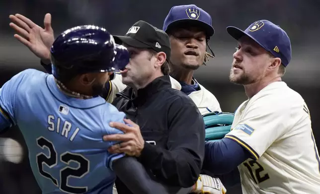 Tampa Bay Rays' Jose Siri (22) fights with Milwaukee Brewers' Abner Uribe, middle, during the eighth inning of a baseball game Tuesday, April 30, 2024, in Milwaukee. (AP Photo/Aaron Gash)
