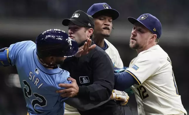 Tampa Bay Rays' Jose Siri (22) fights with Milwaukee Brewers' Abner Uribe, middle, during the eighth inning of a baseball game Tuesday, April 30, 2024, in Milwaukee. (AP Photo/Aaron Gash)