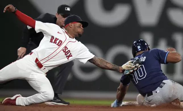 Boston Red Sox shortstop Ceddanne Rafaela, left, tags out Tampa Bay Rays outfielder Amed Rosario (10) on a steal attempt during the ninth inning of a baseball game at Fenway Park, Tuesday, May 14, 2024, in Boston. (AP Photo/Charles Krupa)