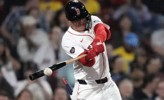 Boston Red Sox's Romy Gonzalez connects on his game-winning RBI single in the 12th inning of a baseball game against the Tampa Bay Rays at Fenway Park, Tuesday, May 14, 2024, in Boston. The Red Sox won 5-4. (AP Photo/Charles Krupa)