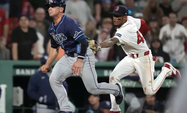Boston Red Sox shortstop Ceddanne Rafaela, right, tags out Tampa Bay Rays' Ben Rortvedt, who got caught in a rundown during the 11th inning of a baseball game at Fenway Park, Tuesday, May 14, 2024, in Boston. (AP Photo/Charles Krupa)