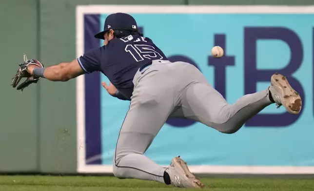 Tampa Bay Rays outfielder Josh Lowe dives but can't make the play on a two-RBI double by Boston Red Sox's Dominic Smith during the fourth inning of a baseball game at Fenway Park, Tuesday, May 14, 2024, in Boston. (AP Photo/Charles Krupa)