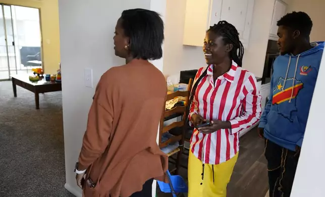 Lutheran Services Carolinas employment specialist Yvonne Songolo, from left, gives Congo refugees Riziki Kashindi and her husband Sadock Ekyochi, a tour of their new apartment, Thursday, April 11, 2024, in Columbia, S.C. The American refugee program, which long served as a haven for people fleeing violence around the world, is rebounding from years of dwindling arrivals under former President Donald Trump. The Biden administration has worked to restaff refugee resettlement agencies and streamline the process of vetting and placing people in America. (AP Photo/Erik Verduzco)