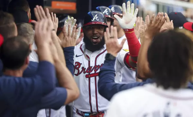 Atlanta Braves' Marcell Ozuna (20) is congratulated for a three-run home run against the Boston Red Sox during the first inning of a baseball game Wednesday, May 8, 2024, in Atlanta. (Jason Getz/Atlanta Journal-Constitution via AP)