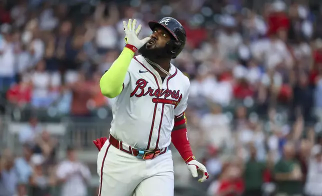 Atlanta Braves' Marcell Ozuna (20) reacts after hitting a three-run home run against the Boston Red Sox during the first inning of a baseball game Wednesday, May 8, 2024, in Atlanta. (Jason Getz/Atlanta Journal-Constitution via AP)