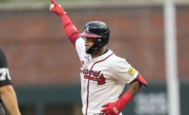 Atlanta Braves' Orlando Arcia gestures as he rounds the bases after hitting a solo home run in the first inning of a baseball game against the Boston Red Sox Wednesday, May 8, 2024, in Atlanta. (AP Photo/John Bazemore)