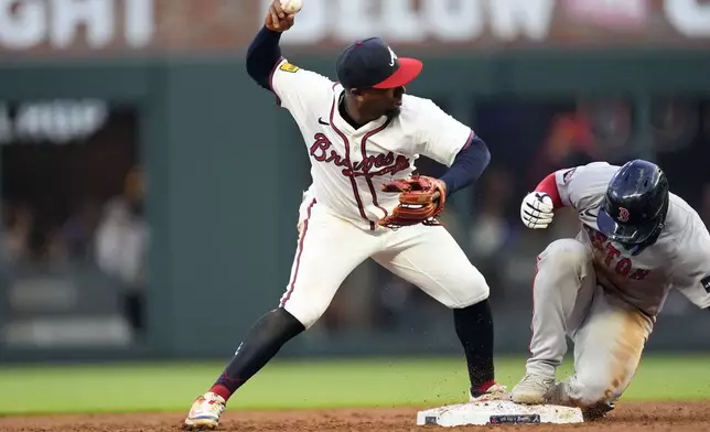 Atlanta Braves second base Ozzie Albies (1) forces out Boston Red Sox' Connor Wong (12) on a ground ball from Tyler O'Neill in the third inning of a baseball game Wednesday, May 8, 2024, in Atlanta. (AP Photo/John Bazemore)