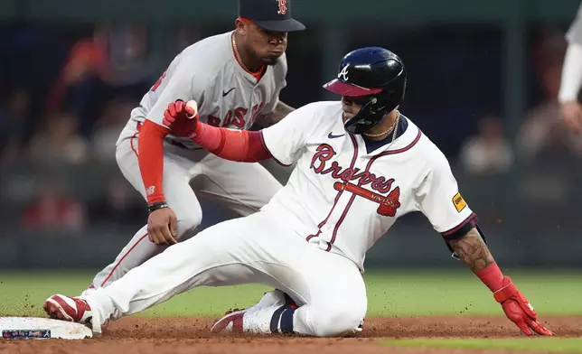 Atlanta Braves' Orlando Arcia slides into second base ahead of the throw to Boston Red Sox shortstop Ceddanne Rafaela with a double in the third inning of a baseball game Wednesday, May 8, 2024, in Atlanta. (AP Photo/John Bazemore)