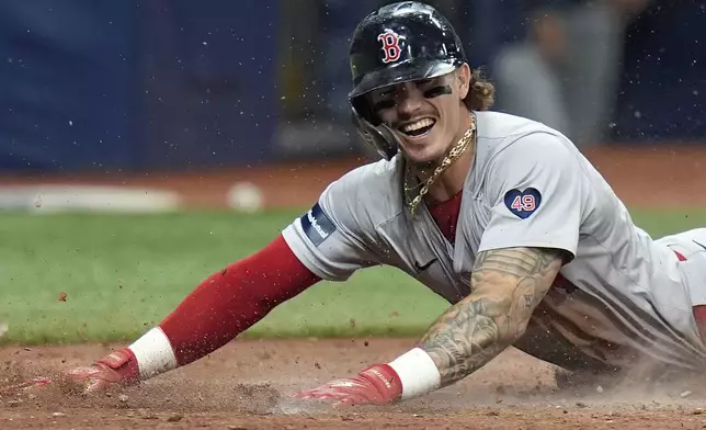 Boston Red Sox's Jarren Dura reacts after steal home plate against the Tampa Bay Rays during the eighth inning of a baseball game Tuesday, May 21, 2024, in St. Petersburg, Fla. (AP Photo/Chris O'Meara)