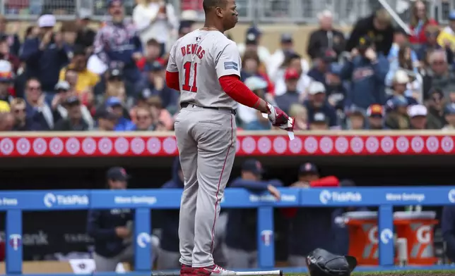 Boston Red Sox's Rafael Devers reacts after striking out against the Minnesota Twins during the fifth inning of a baseball game, Saturday, May 4, 2024, in Minneapolis. (AP Photo/Matt Krohn)