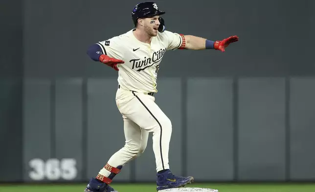 Minnesota Twins' Ryan Jeffers celebrates after his two RBI double against the Boston Red Sox during the seventh inning of a baseball game, Friday, May 3, 2024, in Minneapolis. (AP Photo/Matt Krohn)