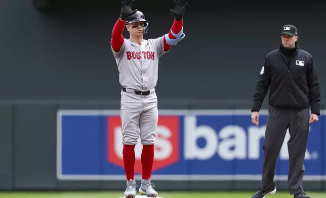 Boston Red Sox Tyler O'Neill celebrates his double against the Minnesota Twins during the first inning of a baseball game, Saturday, May 4, 2024, in Minneapolis. (AP Photo/Matt Krohn)