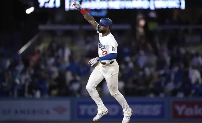 Los Angeles Dodgers' Jason Heyward gestures as he rounds second after hitting a two-run home run during the eighth inning of a baseball game against the Cincinnati Reds Friday, May 17, 2024, in Los Angeles. (AP Photo/Mark J. Terrill)