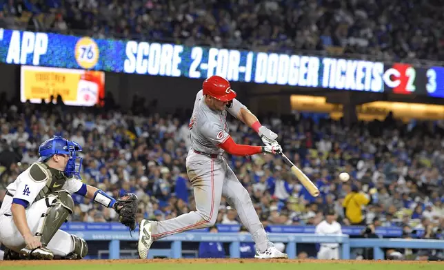 Cincinnati Reds' Tyler Stephenson, right, hits a solo home run as Los Angeles Dodgers catcher Will Smith watches during the sixth inning of a baseball game Friday, May 17, 2024, in Los Angeles. (AP Photo/Mark J. Terrill)