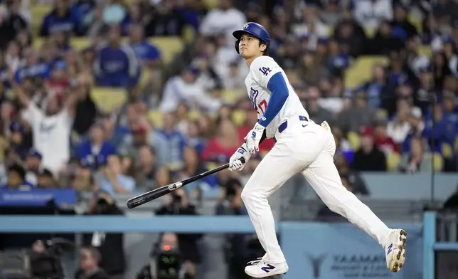 Los Angeles Dodgers designated hitter Shohei Ohtani heads to first after hitting a two-run home run during the third inning of a baseball game against the Cincinnati Reds Friday, May 17, 2024, in Los Angeles. (AP Photo/Mark J. Terrill)