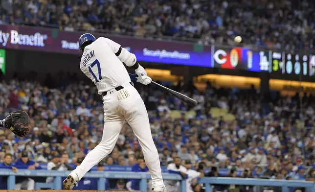 Los Angeles Dodgers designated hitter Shohei Ohtani hits a two-run home run during the third inning of a baseball game against the Cincinnati Reds Friday, May 17, 2024, in Los Angeles. (AP Photo/Mark J. Terrill)