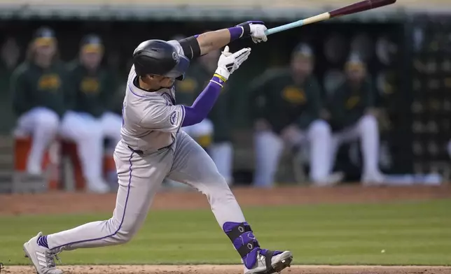 Colorado Rockies' Ezequiel Tovar hits a home run against the Oakland Athletics during the seventh inning of a baseball game in Oakland, Calif., Tuesday, May 21, 2024. (AP Photo/Jeff Chiu)