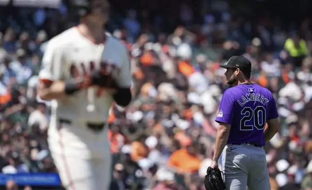 Colorado Rockies pitcher Peter Lambert, right, stands on the field after walking San Francisco Giants' Mike Yastrzemski, foreground, during the sixth inning of a baseball game Saturday, May 18, 2024, in San Francisco. (AP Photo/Godofredo A. Vásquez)