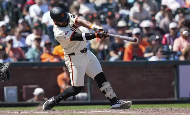 San Francisco Giants' Heliot Ramos hits an RBI single against the Colorado Rockies during the seventh inning of a baseball game Saturday, May 18, 2024, in San Francisco. (AP Photo/Godofredo A. Vásquez)